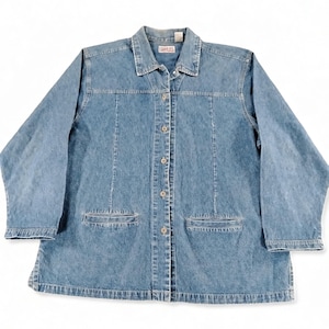 May include: A medium-wash blue denim jacket featuring a classic collar, long sleeves, and a front button-down closure with metallic buttons. The garment includes two horizontal welt pockets at the waist and vertical seam detailing on the front.