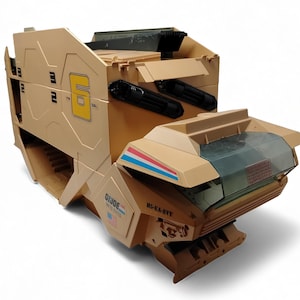 May include: A tan plastic G.I. Joe toy vehicle featuring a large yellow number 6 on the side, a translucent green windshield, and red, white, and blue stripes. The side displays the text G.I. Joe United States, a small American flag, and H5-EA-8VY.