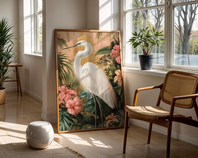 Great egret art print featuring a graceful white heron standing among lush tropical leaves and colourful flowers. Detailed wildlife artwork with elegant composition, perfect for bird lovers and nature enthusiasts. Botanical tropical painting that adds sophistication and serenity to any living room, bedroom, office, or nursery, creating a calming atmosphere. Wildlife inspired wall decor that highlights the beauty of the egret and the harmony of nature through vibrant colours and refined design.