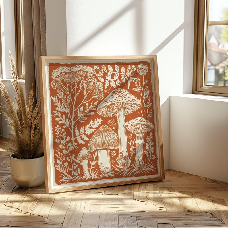 Autumn mushroom art print featuring a tall central mushroom surrounded by smaller mushrooms and woodland botanicals in warm earthy tones. Detailed fall botanical illustration that captures the beauty of forest landscapes, ideal for rustic kitchens, autumn cottagecore interiors, woodland décor or seasonal gallery walls. Perfect mushroom wall art for adding warm autumn charm and woodland character to any space.