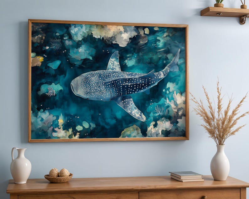 a large framed painting of a whale shark swimming in the ocean, hanging on a wall above a wooden dresser.