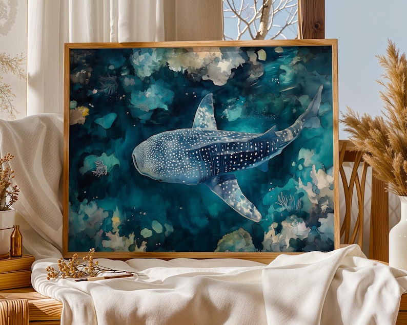 a large framed painting of a whale shark swimming in the ocean, with a wooden frame and a white cloth on a table.