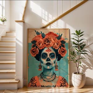 a large framed artwork depicting a colorful, stylized portrait of a woman with a skull-like face, adorned with flowers and intricate patterns. The artwork is displayed in a hallway with a staircase and a potted plant nearby.