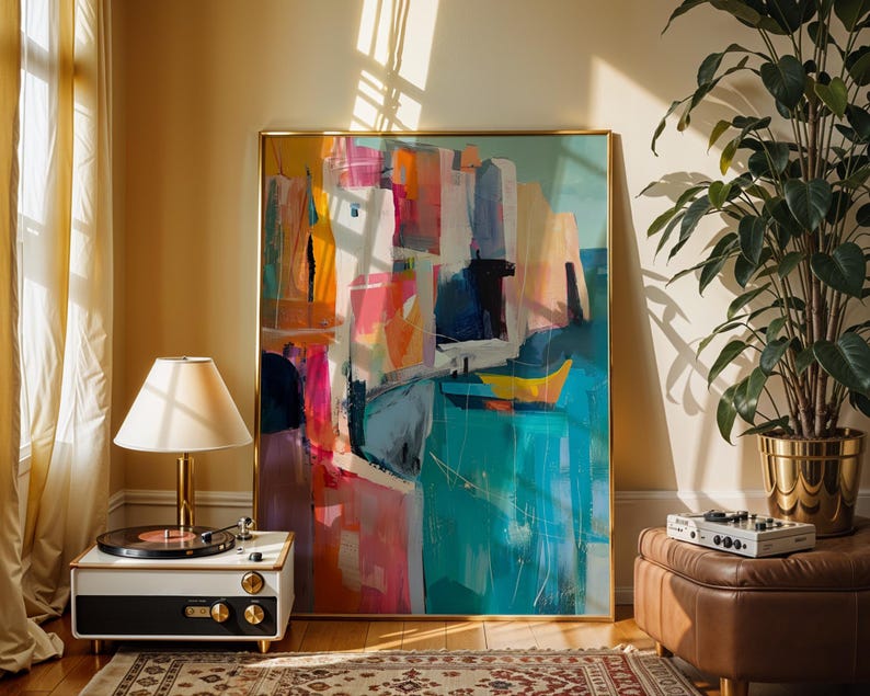 a large abstract painting displayed in a room with a record player, a lamp, and a potted plant.