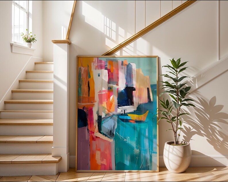 a large, colorful abstract painting displayed on a wall, with a staircase and a potted plant in the background.