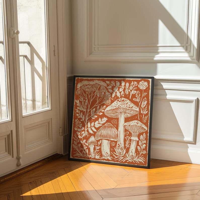 Autumn mushroom art print featuring a tall central mushroom surrounded by smaller mushrooms and woodland botanicals in warm earthy tones. Detailed fall botanical illustration that captures the beauty of forest landscapes, ideal for rustic kitchens, autumn cottagecore interiors, woodland décor or seasonal gallery walls. Perfect mushroom wall art for adding warm autumn charm and woodland character to any space.