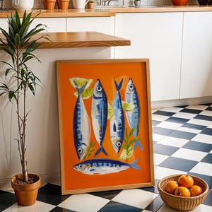 a kitchen scene with a framed artwork of fish on the floor, a potted plant, a basket of oranges, and a checkered tile floor.