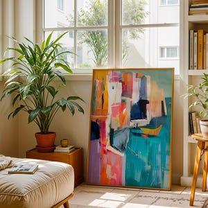 a cozy living room with a large abstract painting on the wall, a comfortable sofa, and two potted plants. The room is filled with natural light from the windows, creating a warm and inviting atmosphere.