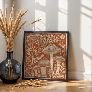 Autumn mushroom art print featuring a tall central mushroom surrounded by smaller mushrooms and woodland botanicals in warm earthy tones. Detailed fall botanical illustration that captures the beauty of forest landscapes, ideal for rustic kitchens, autumn cottagecore interiors, woodland décor or seasonal gallery walls. Perfect mushroom wall art for adding warm autumn charm and woodland character to any space.