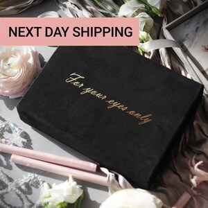 May include: A black box with gold lettering that reads "For your eyes only" is surrounded by flowers and wax sticks. A photo of a couple is visible in the background. The text "NEXT DAY SHIPPING" is in a pink rectangle.