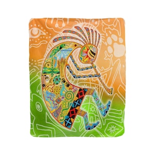 May include: A colorful blanket featuring a Kokopelli design. The blanket has a gradient background of green and orange, with a detailed illustration of Kokopelli playing a flute. The Kokopelli figure is adorned with various patterns and colors, including blue, yellow, and red.