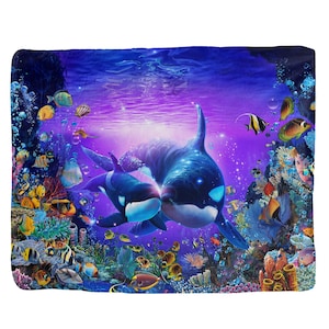 May include: A vibrant underwater scene with two orcas swimming in a coral reef. The orcas are blue and black with white markings. The coral reef is filled with colorful fish and plants. The background is a purple and blue gradient.