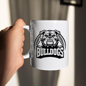 May include: White ceramic mug with a black and white illustration of a bulldog with the text "BULLDOGS" underneath.