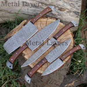 May include: Set of five kitchen knives with wooden handles and Damascus steel blades. The knives are arranged on a wooden stump.