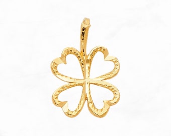 May include: A gold four-leaf clover charm pendant with a textured design.