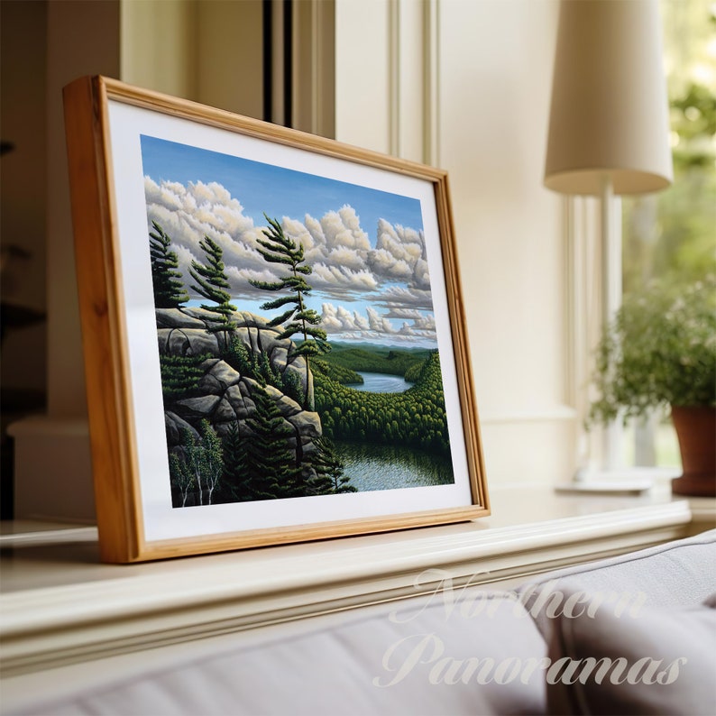 May include: A framed painting of a landscape scene with a lake, trees, and clouds. The painting is in a wooden frame and is hanging on a wall.