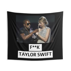 May include: Black and white tapestry with a photo of two people on stage. The text "F**K TAYLOR SWIFT" is printed in white on a black background.