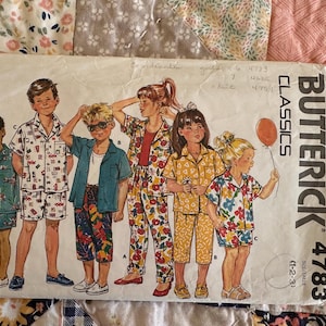 May include: A sewing pattern for children's pajamas. The pattern includes five different designs, featuring a variety of colors and patterns. The pattern is from Butterick and is number 4783.