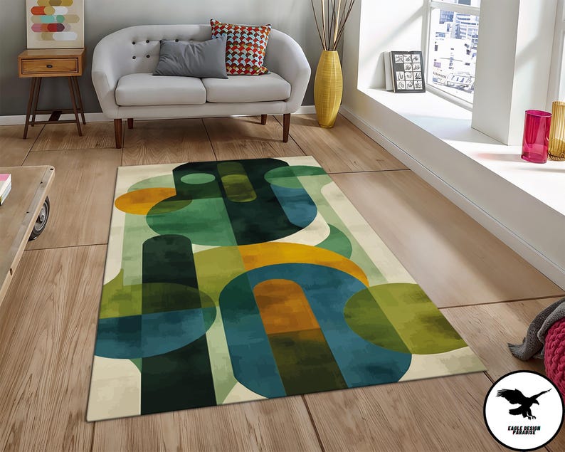 May include: Abstract area rug with a geometric design featuring overlapping circles in shades of green, blue, and yellow on a cream background.
