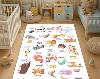 May include: A white alphabet rug with colorful illustrations of animals and letters. The rug features a zebra, a unicorn, an elephant, a giraffe, a monkey, a fish, a bird, a raccoon, a yak, a tiger, a squirrel, a turtle, a jellyfish, a seahorse, a panda, a koala, a wolf, a lion, a hedgehog, a cow, a deer, a penguin, a parrot, a kangaroo, and a snake.