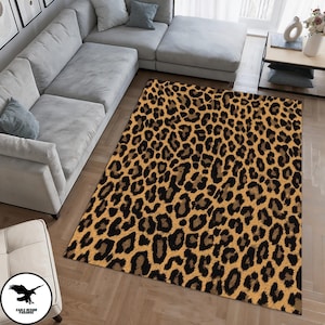 May include: A brown and black leopard print area rug with a soft, fuzzy texture. The rug is laid out on a hardwood floor in a living room setting.