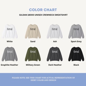 May include: Color chart showing different color options for a Gildan 18000 unisex crewneck sweatshirt. The sweatshirt has the word "feral" printed on the front in a white font. The colors shown are white, sand, ash, sport grey, graphite heather, military green, dark heather, and black.