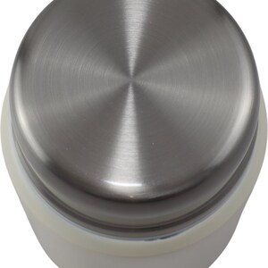 May include: A stainless steel lid with a brushed metal finish. The lid is circular with a central point and is attached to a white base. The image is a top-down view of the lid.