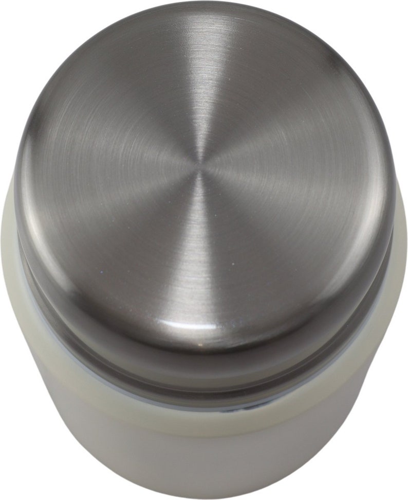 May include: A stainless steel lid with a brushed metal finish. The lid is circular with a central point and is attached to a white base. The image is a top-down view of the lid.