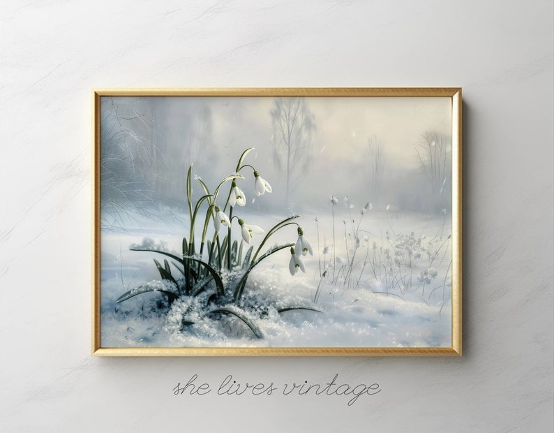 May include: A framed painting of a snowy forest scene with white snowdrops blooming in the foreground. The painting has a soft, dreamy feel and features a light blue and white color palette.