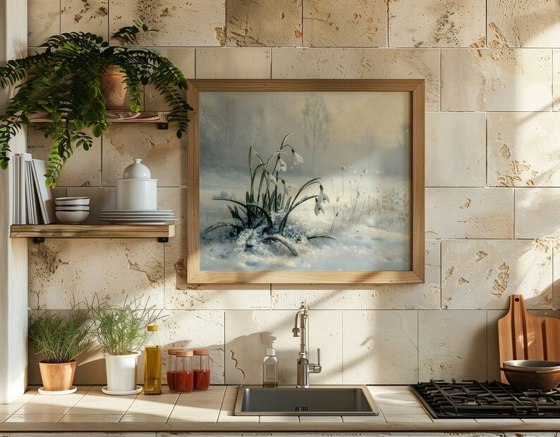 May include: A framed painting of a snowy landscape with white snowdrops in bloom. The painting is hanging on a wall with beige tiles.