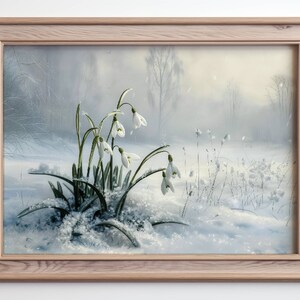 May include: A framed painting of a snowy winter scene with a cluster of white snowdrops blooming in the foreground. The background is a soft, hazy blue with trees and a hint of sunlight.
