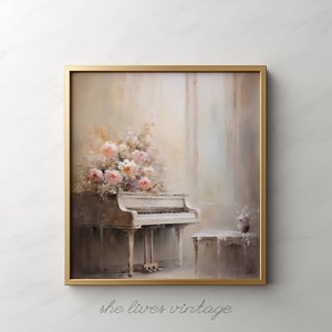 May include: A framed painting featuring a white grand piano adorned with pink and white flowers. The artwork has a soft, muted color palette with a gold frame. The text "she lives vintage" is at the bottom.