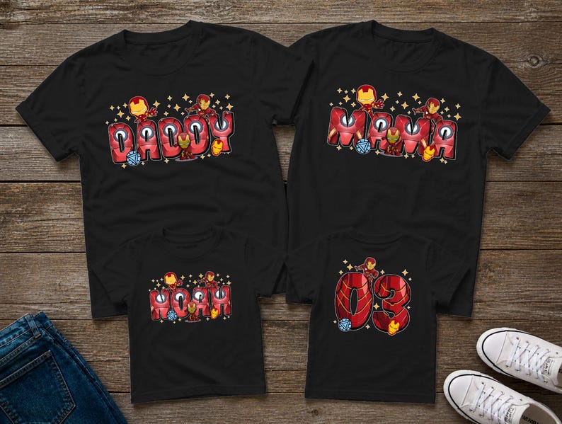 May include: Four black t-shirts with Iron Man-themed designs. Two shirts say "Daddy" and "Mama" in red bubble letters with Iron Man graphics. The other two shirts have "03" and "Mom" in similar styles. Family matching apparel.