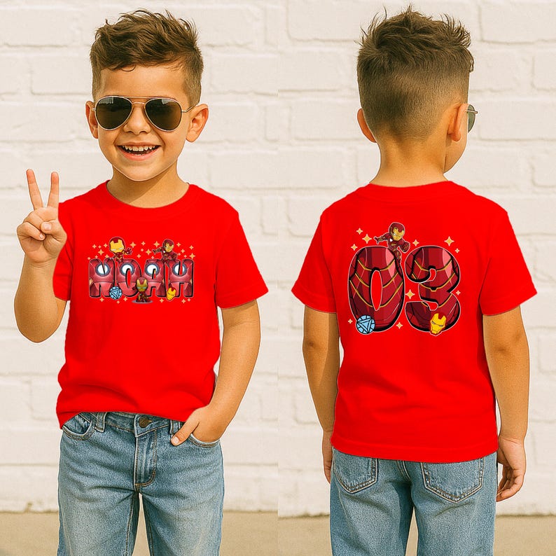 May include: Red t-shirt featuring the word "IRON" with Iron Man graphics and the number "03" on the back. The shirt is worn by a child wearing sunglasses and blue jeans.