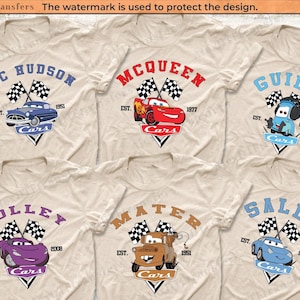 Può includere: Sei magliette beige con personaggi di Cars stampati su di esse. Ogni maglietta presenta un personaggio diverso del film Cars, tra cui Doc Hudson, McQueen, Guido, Holley, Mater e Sally. Le magliette hanno il nome del personaggio, il titolo del film "Cars" e l'anno in cui il personaggio è stato fondato.