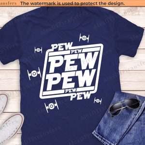 May include: A navy blue t-shirt with a white graphic design featuring the text "PEW PEW PEW PEW" in a square shape. The graphic also includes four small white TIE fighter symbols.