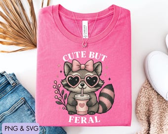 Cute But Feral Png Svg, Kids Shirt Png, Meme Funny Raccoon Shirt, Raccoon Aesthetic Png, Raccoon with Bow Png, Retro Natural Design Png Svg