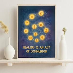 May include: A framed art print with a blue and gold celestial design. The artwork features a spiral of illuminated figures and symbols against a starry background. The text "HEALING IS AN ACT OF COMMUNION" is at the bottom.