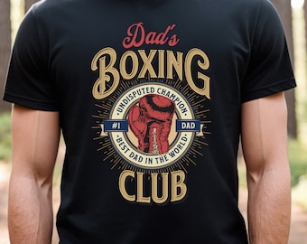 May include: Black t-shirt with a vintage-style graphic that says "Dad's Boxing Club" with a boxing glove and the text "Undisputed Champion #1 Best Dad in the World Dad".