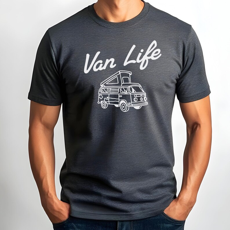 May include: Dark gray t-shirt with the white text "Van Life" above a white illustration of a camper van. The van has an open top and is detailed with windows and wheels. The shirt is short-sleeved.
