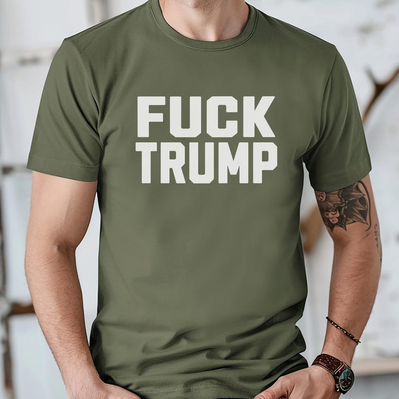 May include: A green t-shirt with the text "FUCK TRUMP" printed in white.