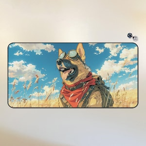 May include: A brown and white German Shepherd dog wearing goggles and a red bandana, standing in a field of tall grass with a blue sky and white clouds in the background.