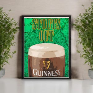 May include: Framed print featuring a pint of Guinness stout with a creamy head. The background is a green map with the words "STOUTS OUT" in gold lettering. The Guinness logo is visible on the glass.