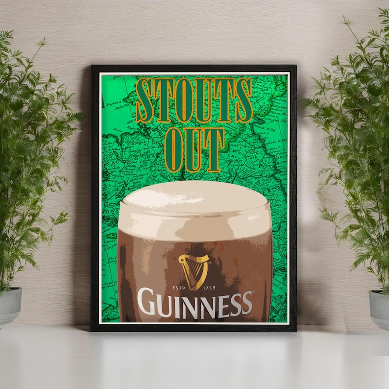 May include: Framed print featuring a pint of Guinness stout with a creamy head. The background is a green map with the words "STOUTS OUT" in gold lettering. The Guinness logo is visible on the glass.