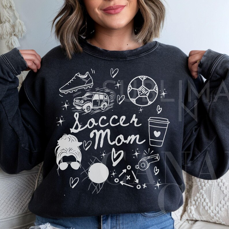 May include: Black sweatshirt with a white graphic design featuring a soccer ball, car, coffee cup, and the text "Soccer Mom".