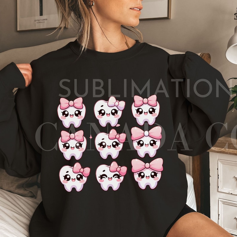 May include: Black sweatshirt with a sublimation design of nine white teeth with pink bows. Each tooth has a different facial expression.