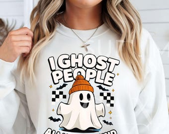 May include: White sweatshirt with a graphic of a friendly ghost wearing an orange beanie. The text reads "I Ghost People All Year Round". Black bats and checkered flags are also featured in the design.