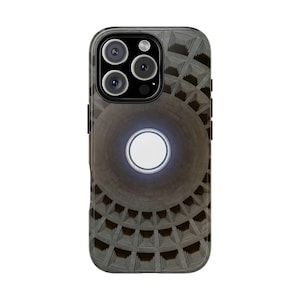 May include: A black and gray phone case featuring a detailed illustration of a domed ceiling with a central oculus. The design includes a circular, glowing white element at the center, and a camera array at the top.