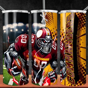 May include: A stainless steel tumbler with a graphic of a football player wearing a red and gold helmet and jersey. The player is depicted as a skeleton with glowing red eyes. The tumbler has a black background with a yellow and brown pattern and the word "COMMANDERS" in large letters.