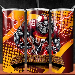 May include: A red and yellow stainless steel tumbler with a graphic of a football player wearing a helmet and holding a football. The player is wearing a red jersey with the word "Commanders" on it. The background is a yellow and red pattern with lightning bolts.